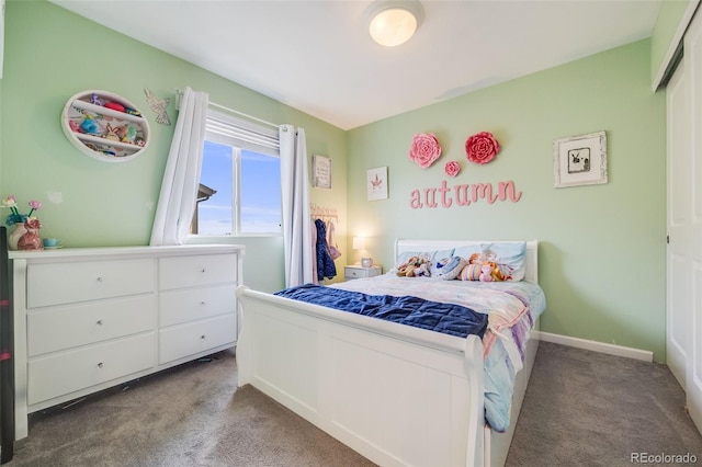 bedroom with carpet floors and baseboards