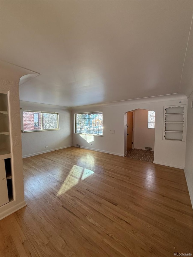 unfurnished living room featuring hardwood / wood-style flooring