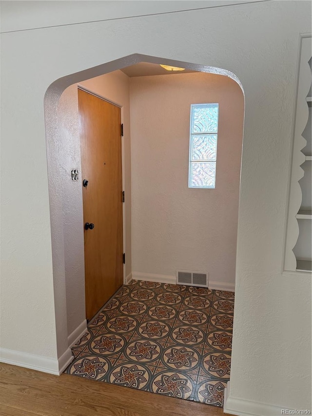 corridor with tile patterned flooring