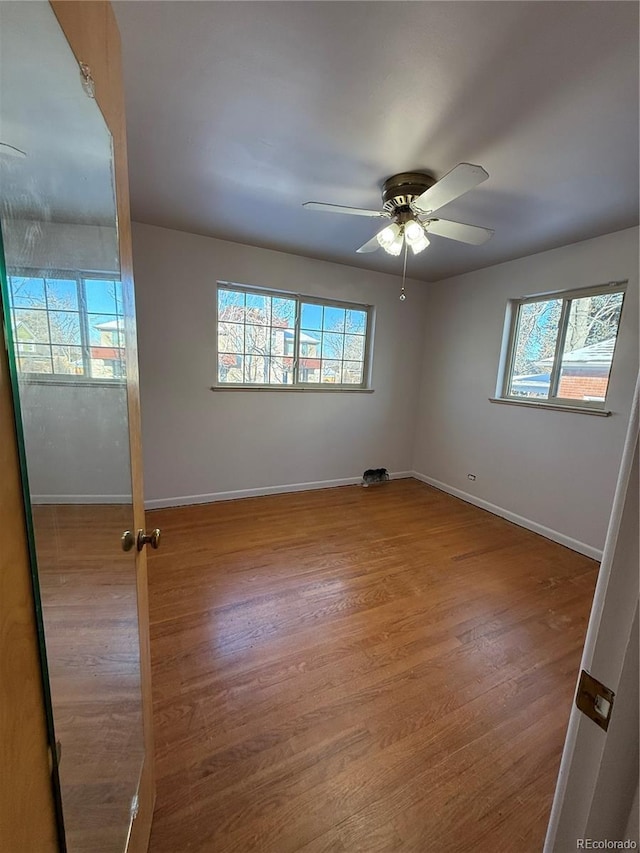 unfurnished room with ceiling fan and light wood-type flooring