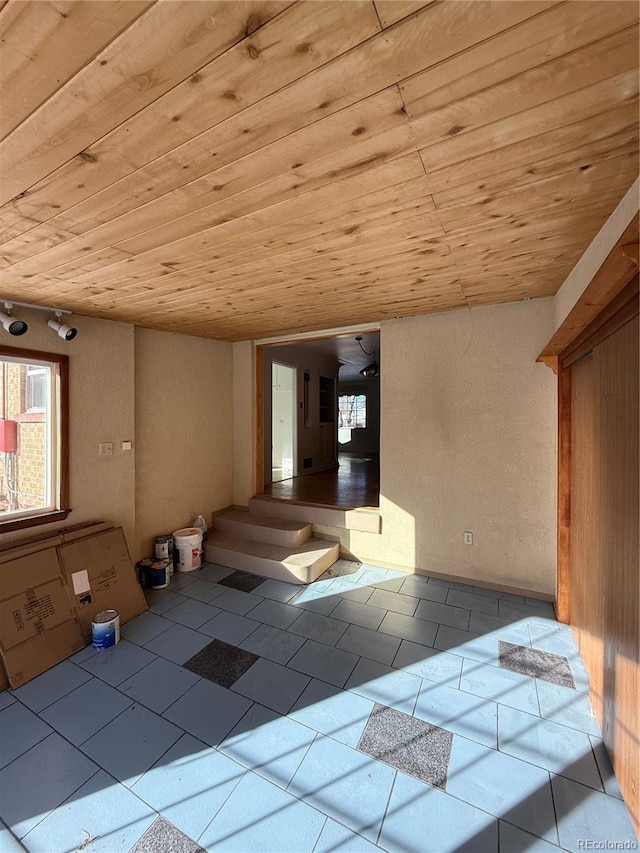 interior space featuring light tile patterned floors and wooden ceiling