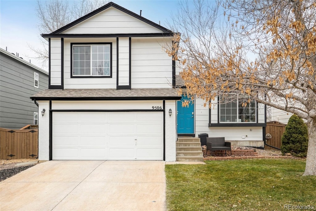 view of front of home featuring a garage and a front lawn