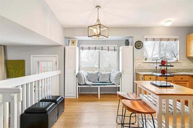 interior space with light wood-type flooring and an inviting chandelier