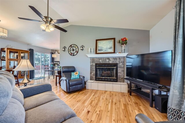 7716 Shenandoah Dr, Elizabeth, CO 80107 - living area with lofted ceiling, wood-type flooring, a ceiling fan, and a fireplace