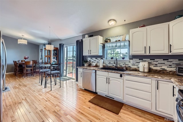 7716 Shenandoah Dr, Elizabeth, CO 80107 - kitchen with stainless steel appliances, a sink, decorative backsplash, and healthy amount of natural light