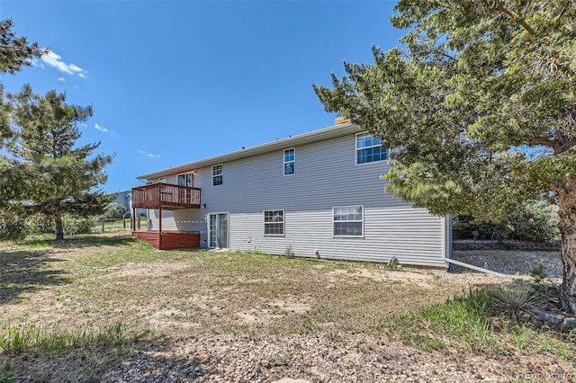 7716 Shenandoah Dr, Elizabeth, CO 80107 - rear view of house featuring a jacuzzi and a deck