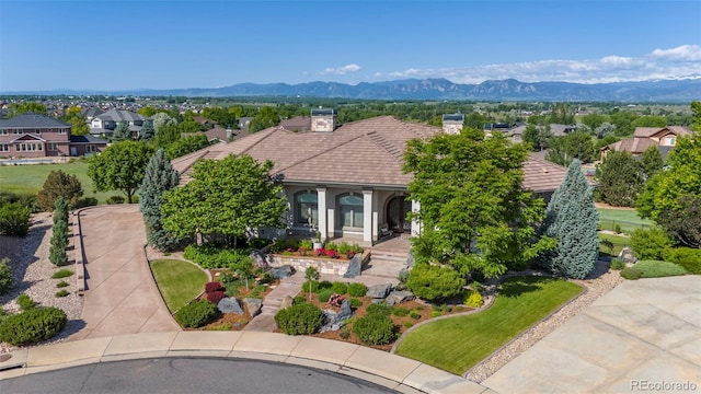 2378 Plumb Pl, Erie, CO 80516 - mediterranean / spanish house featuring a chimney, a mountain view, a residential view, and a tile roof