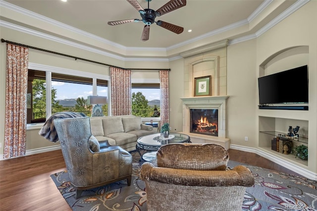 2378 Plumb Pl, Erie, CO 80516 - living room with wood finished floors, plenty of natural light, a glass covered fireplace, ornamental molding, and recessed lighting