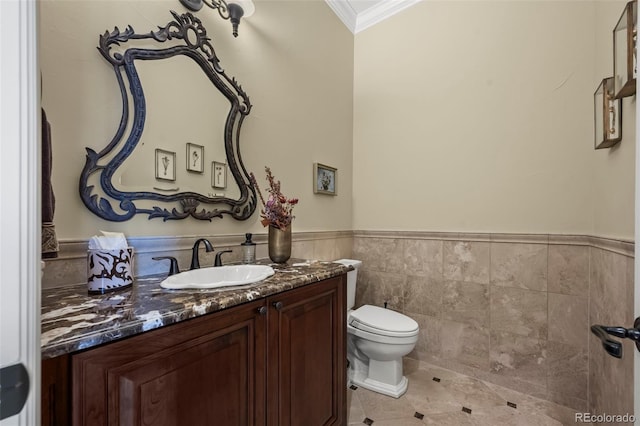 2378 Plumb Pl, Erie, CO 80516 - bathroom featuring ornamental molding, vanity, tile walls, a wainscoted wall, and tile patterned floors