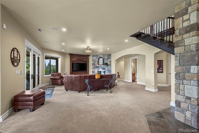 2378 Plumb Pl, Erie, CO 80516 - living room featuring carpet floors, arched walkways, recessed lighting, and stairs