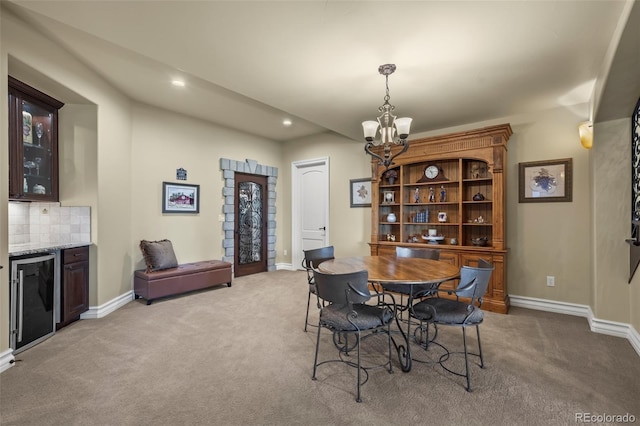 2378 Plumb Pl, Erie, CO 80516 - dining space with light carpet, a chandelier, recessed lighting, beverage cooler, and bar