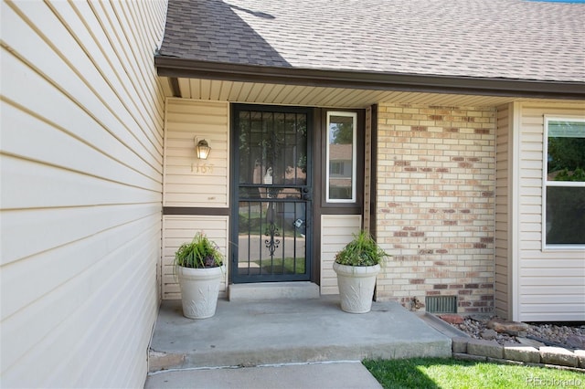 1168 E Kettle Pl, Centennial, CO 80122 - property entrance featuring brick siding, roof with shingles, and a porch