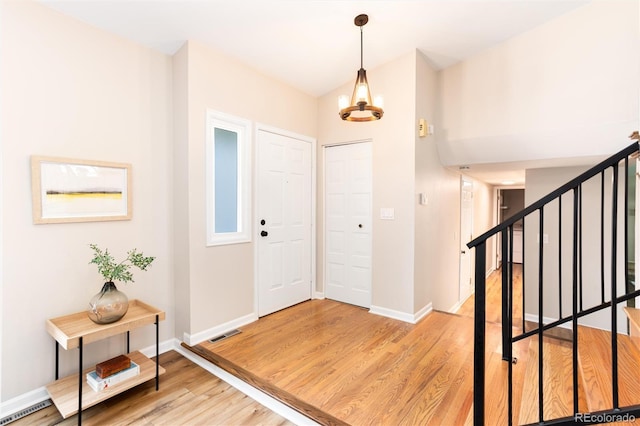 1168 E Kettle Pl, Centennial, CO 80122 - foyer with a chandelier, light wood finished floors, and stairs