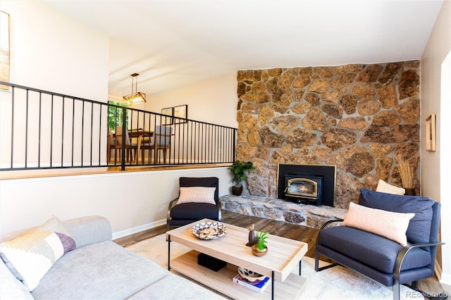 1168 E Kettle Pl, Centennial, CO 80122 - living area with wood finished floors, vaulted ceiling, and a stone fireplace