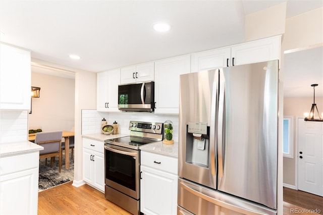 1168 E Kettle Pl, Centennial, CO 80122 - kitchen with stainless steel appliances, light wood-type flooring, backsplash, white cabinets, and light stone counters