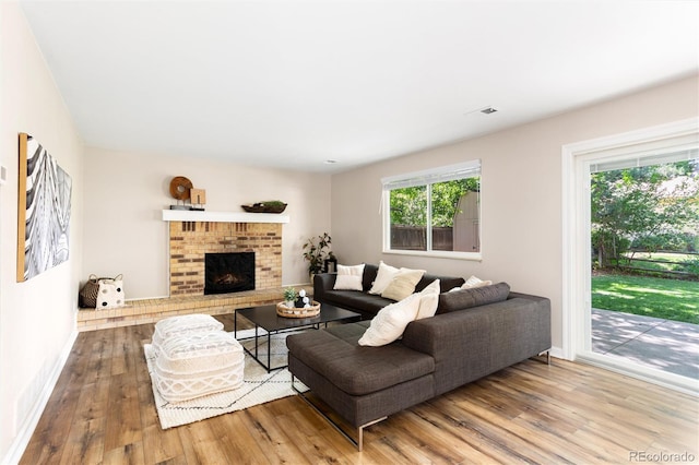 1168 E Kettle Pl, Centennial, CO 80122 - living area featuring wood-type flooring and a brick fireplace