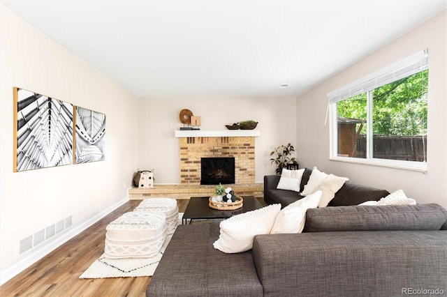 1168 E Kettle Pl, Centennial, CO 80122 - living area with wood finished floors and a brick fireplace