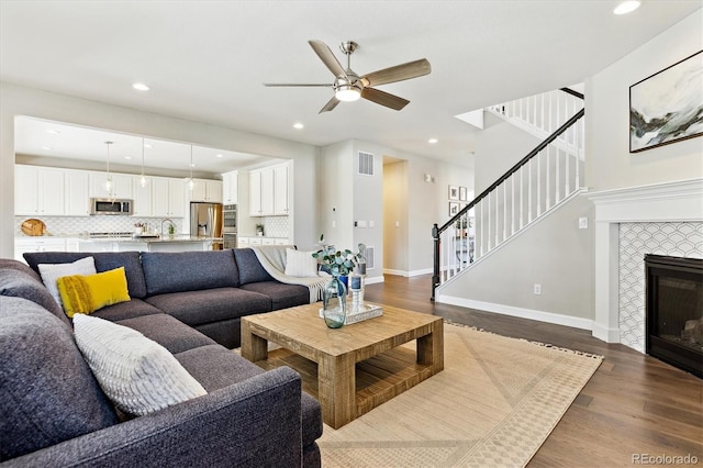 8102 Adams Fork Ave, Littleton, CO 80125 - living room with stairs, dark wood-style floors, a ceiling fan, recessed lighting, and baseboards