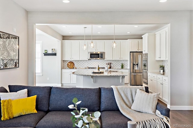 8102 Adams Fork Ave, Littleton, CO 80125 - living area featuring recessed lighting, wood finished floors, and baseboards