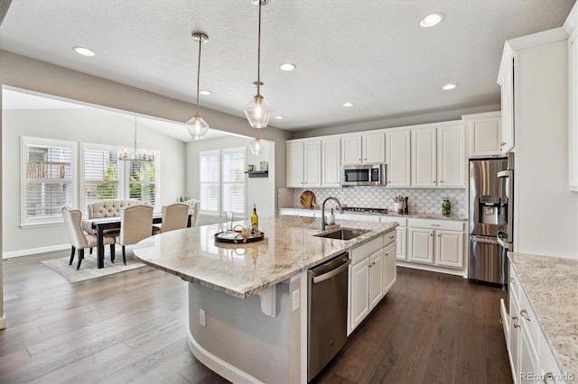 8102 Adams Fork Ave, Littleton, CO 80125 - kitchen featuring appliances with stainless steel finishes, a sink, white cabinets, tasteful backsplash, and dark wood-type flooring