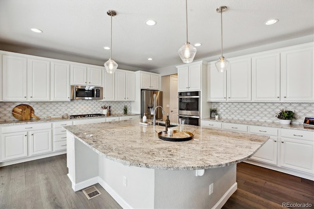 8102 Adams Fork Ave, Littleton, CO 80125 - kitchen with stainless steel appliances, tasteful backsplash, white cabinetry, and recessed lighting