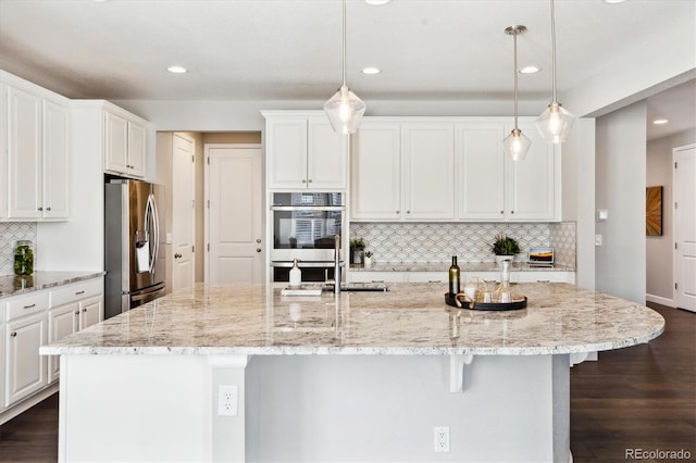 8102 Adams Fork Ave, Littleton, CO 80125 - kitchen with stainless steel appliances, white cabinets, a large island, tasteful backsplash, and light stone counters