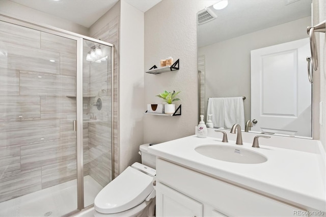 8102 Adams Fork Ave, Littleton, CO 80125 - full bathroom with vanity, a shower stall, toilet, and a textured wall