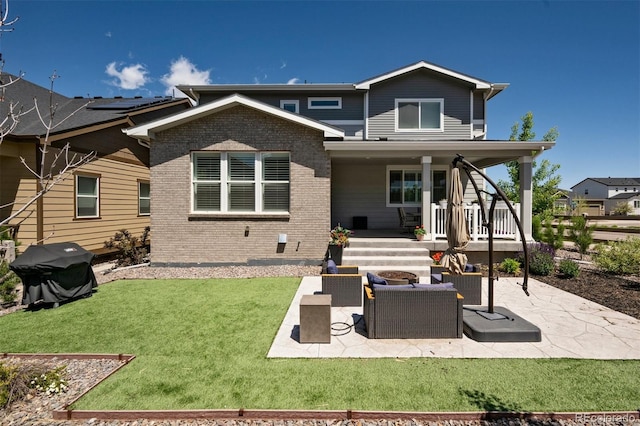 8102 Adams Fork Ave, Littleton, CO 80125 - back of house with brick siding, a lawn, a patio area, and covered porch