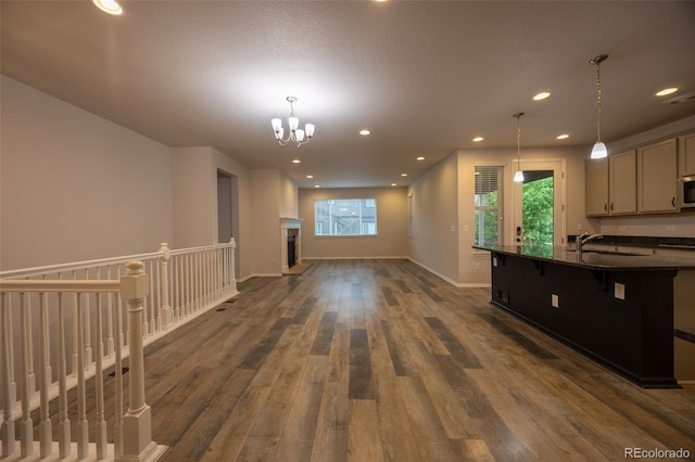 kitchen with dark wood-style flooring, open floor plan, a chandelier, recessed lighting, and decorative light fixtures