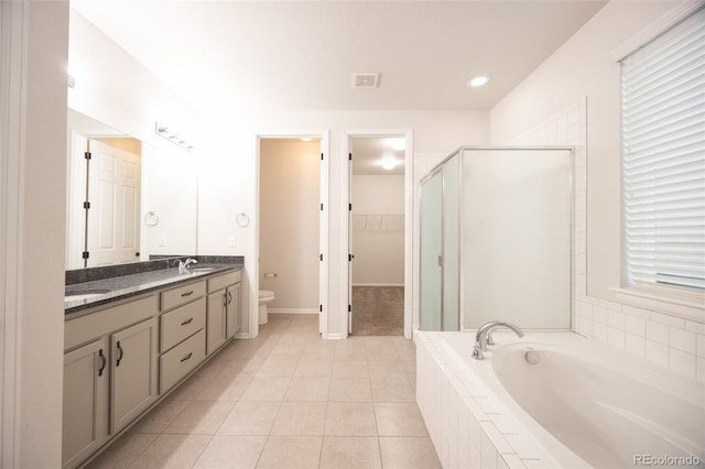 full bath with a shower stall, a bath, toilet, double vanity, and tile patterned flooring