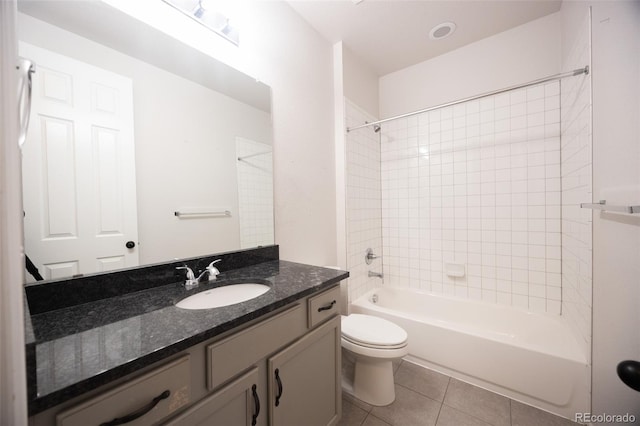 bathroom with tile patterned floors, toilet, vanity, and tub / shower combination