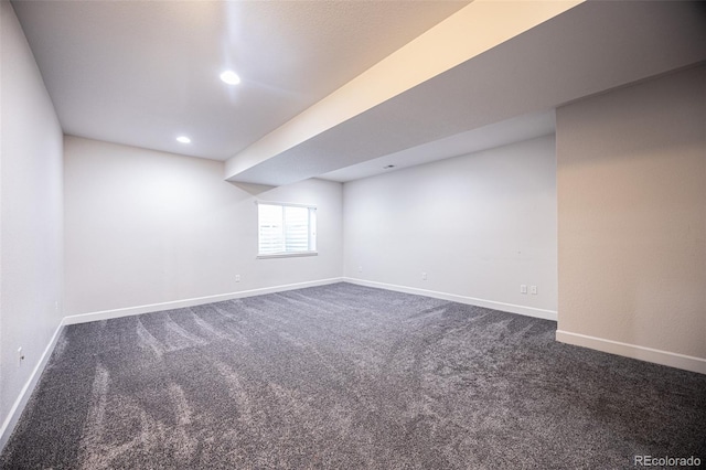 basement with dark colored carpet, baseboards, and recessed lighting