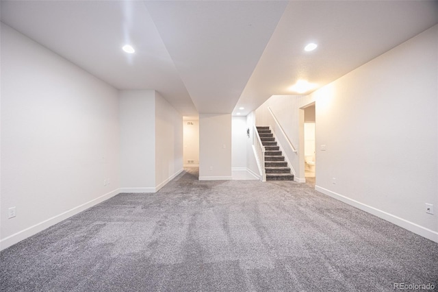 finished basement featuring stairs, carpet floors, baseboards, and recessed lighting