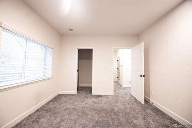 unfurnished bedroom with carpet and baseboards