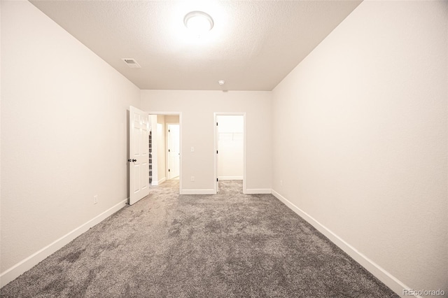 carpeted spare room featuring baseboards