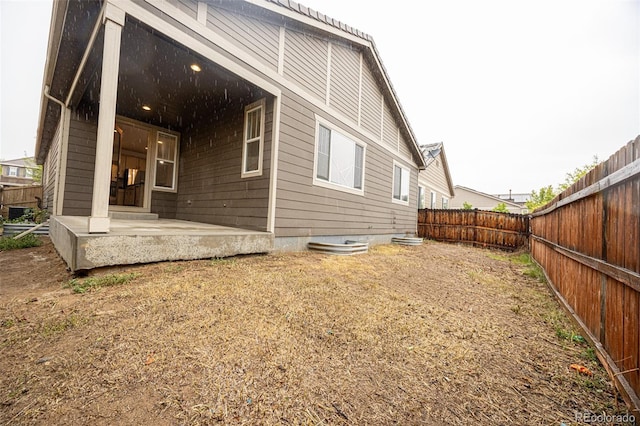 back of house featuring a fenced backyard