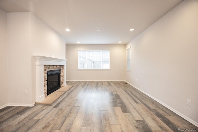 12652 Glencoe St, Thornton, CO 80241 - unfurnished living room with wood finished floors, a fireplace, recessed lighting, and baseboards