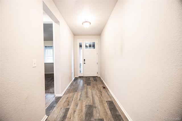 12652 Glencoe St, Thornton, CO 80241 - entryway featuring dark wood-style floors, baseboards, and a textured wall