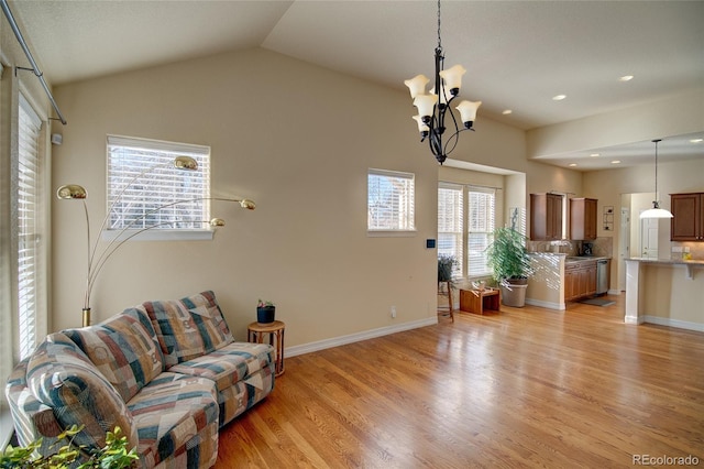 living room featuring light wood-type flooring, recessed lighting, baseboards, lofted ceiling, and a chandelier