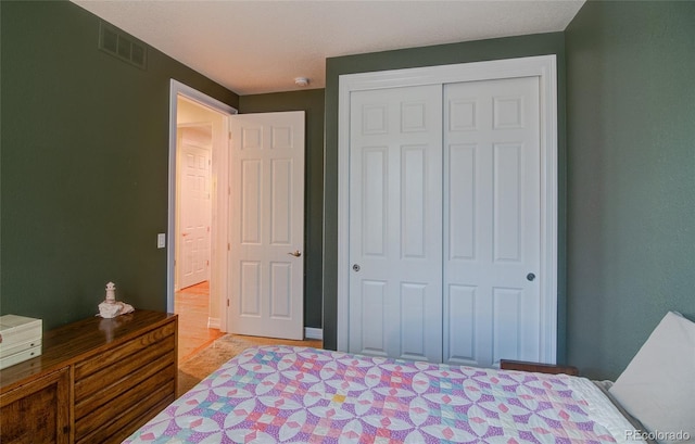 bedroom featuring visible vents and a closet