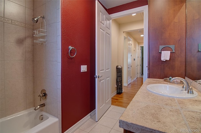 bathroom featuring vanity, tile patterned floors, baseboards, and shower / bath combination