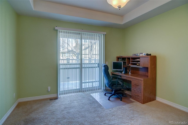 office with a raised ceiling, carpet, and baseboards