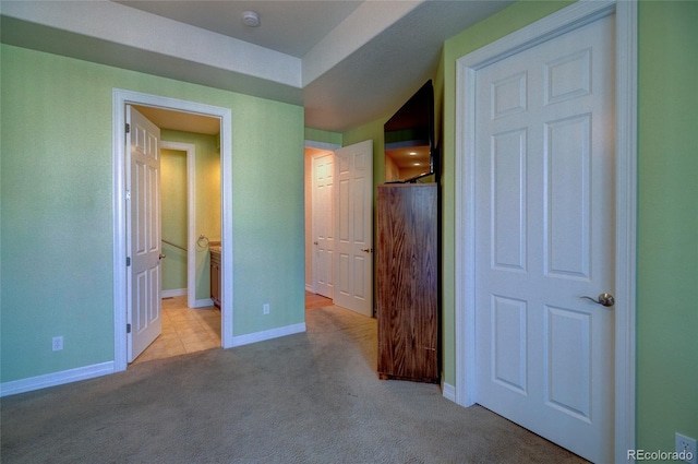 unfurnished bedroom featuring baseboards and carpet floors