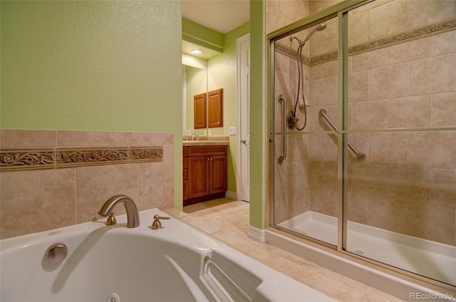 bathroom featuring vanity, a whirlpool tub, and a shower stall