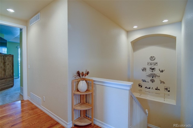 hall featuring recessed lighting, visible vents, baseboards, and light wood-style floors