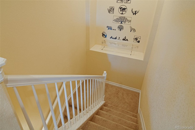 stairs with baseboards and carpet flooring