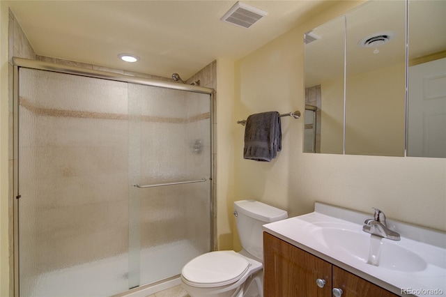 bathroom featuring visible vents, a stall shower, toilet, and vanity