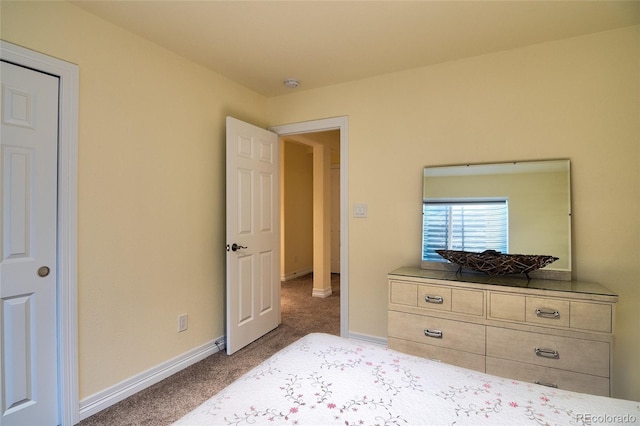 carpeted bedroom featuring baseboards