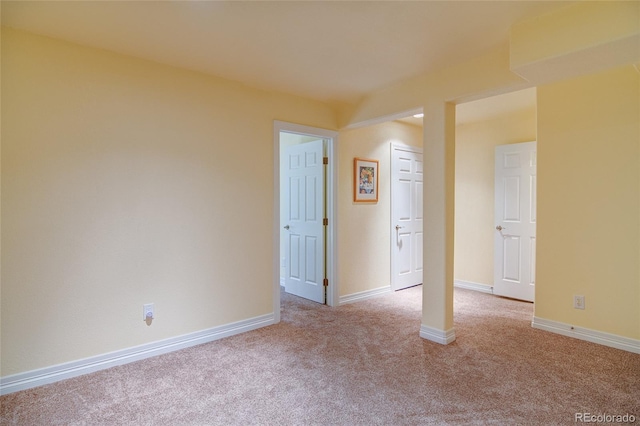 carpeted spare room with baseboards