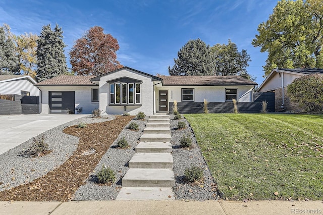 ranch-style house with a garage and a front lawn